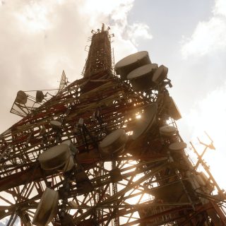 A telecommunications tower with multiple antennas for mobile network coverage.
