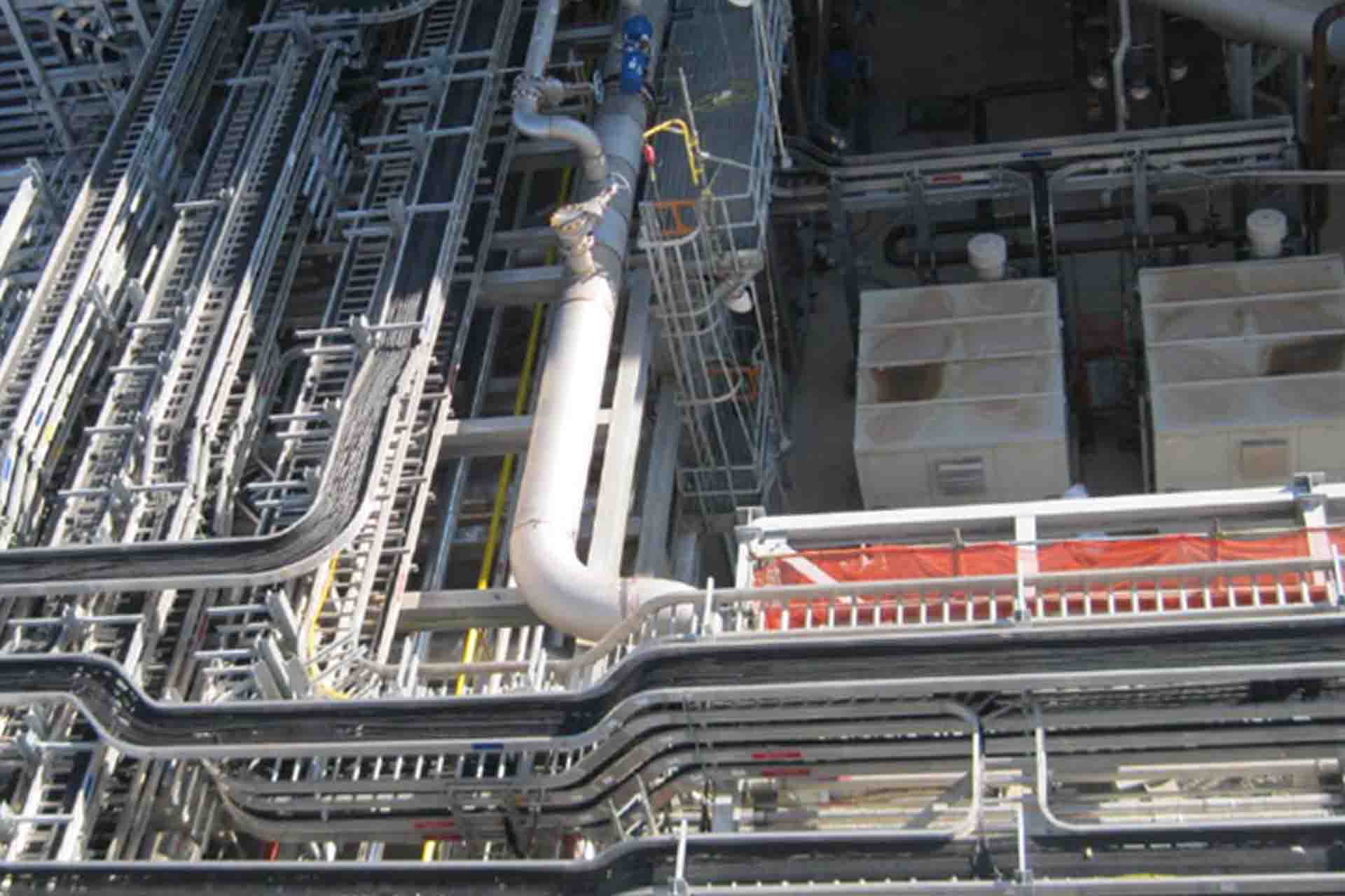 An assortment of different types of cable trays, including ladder and perforated, used for industrial cable management.