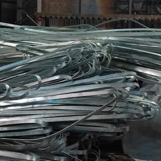 A coil of galvanized iron (GI) earthing strip used for electrical grounding in industrial applications.