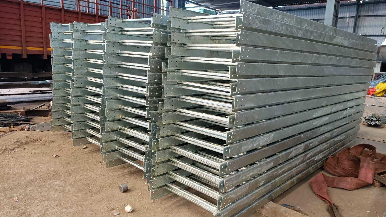 Industrial ladder-type cable tray with two side rails connected by rungs, supporting heavy-duty electrical wiring.